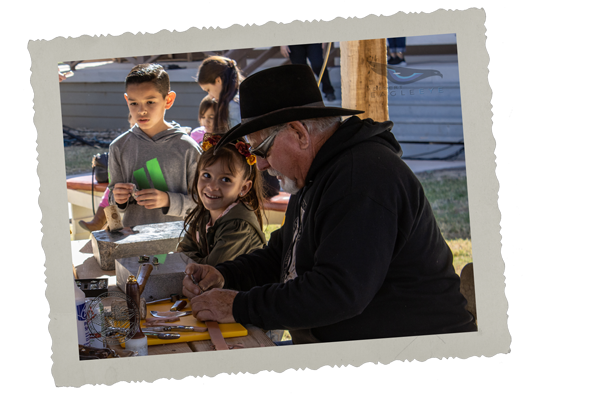 Leather tooling demonstration at Pioneers' Day.